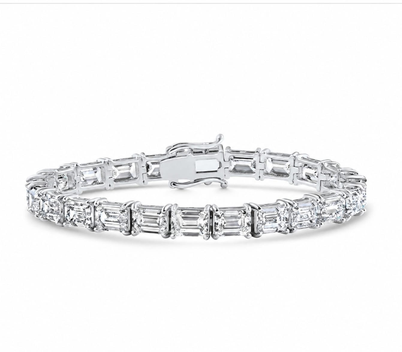 A silver tennis bracelet featuring baguette-cut clear stones in a continuous link design, displayed on a clean white background.