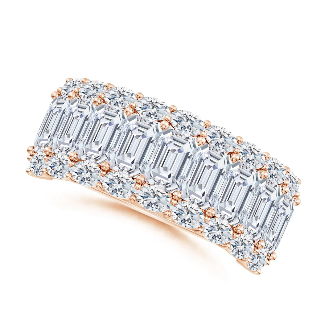 Diamond ring with emerald-cut stones and rose gold accents on a white background