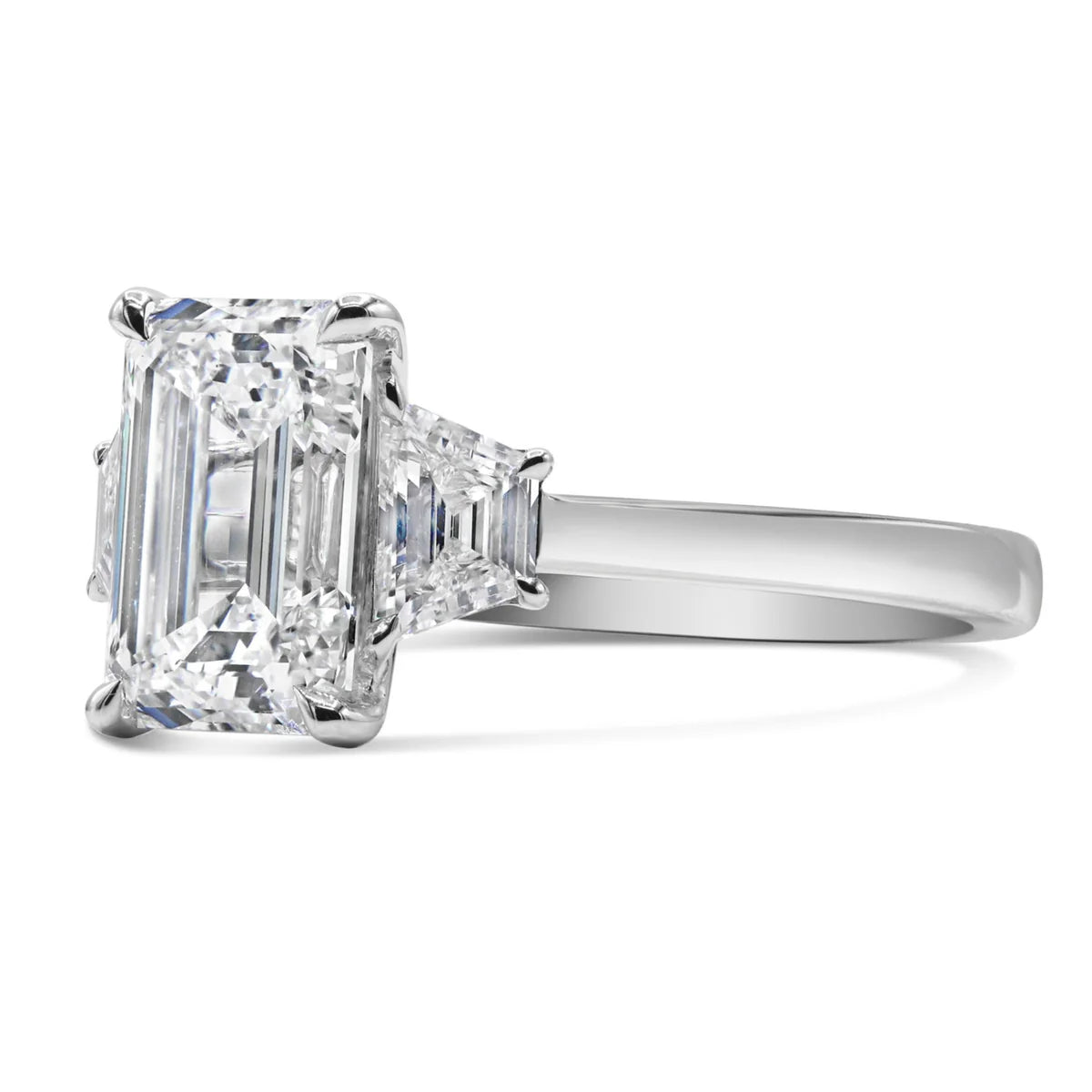 Emerald and Step Cut Trapezoid Three Stone Ring