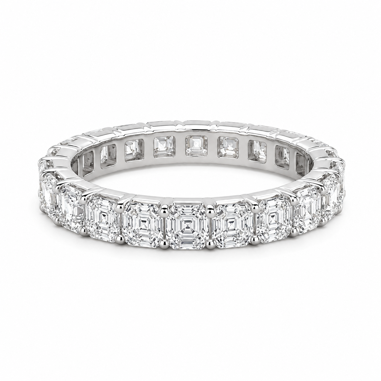 A diamond eternity ring in a silver-colored metal setting, featuring baguette and round-cut diamonds, shown on a clean white background.