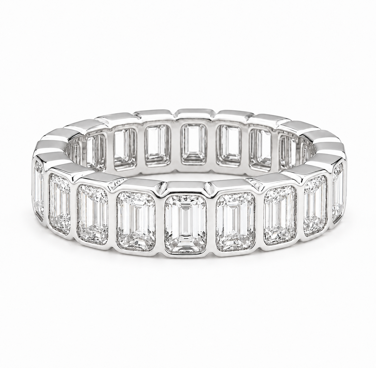 A silver-toned eternity ring featuring a continuous row of baguette-cut clear gemstones in a polished setting, shown against a plain white background.
