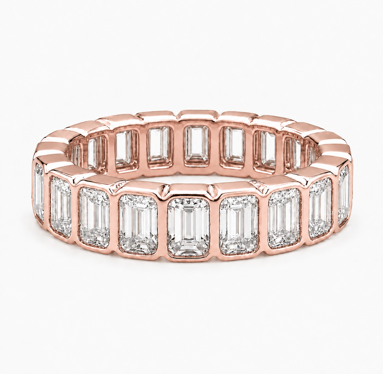 A rose gold eternity ring featuring a continuous row of baguette-cut clear gemstones in a polished rose gold setting, shown on a clean white background.