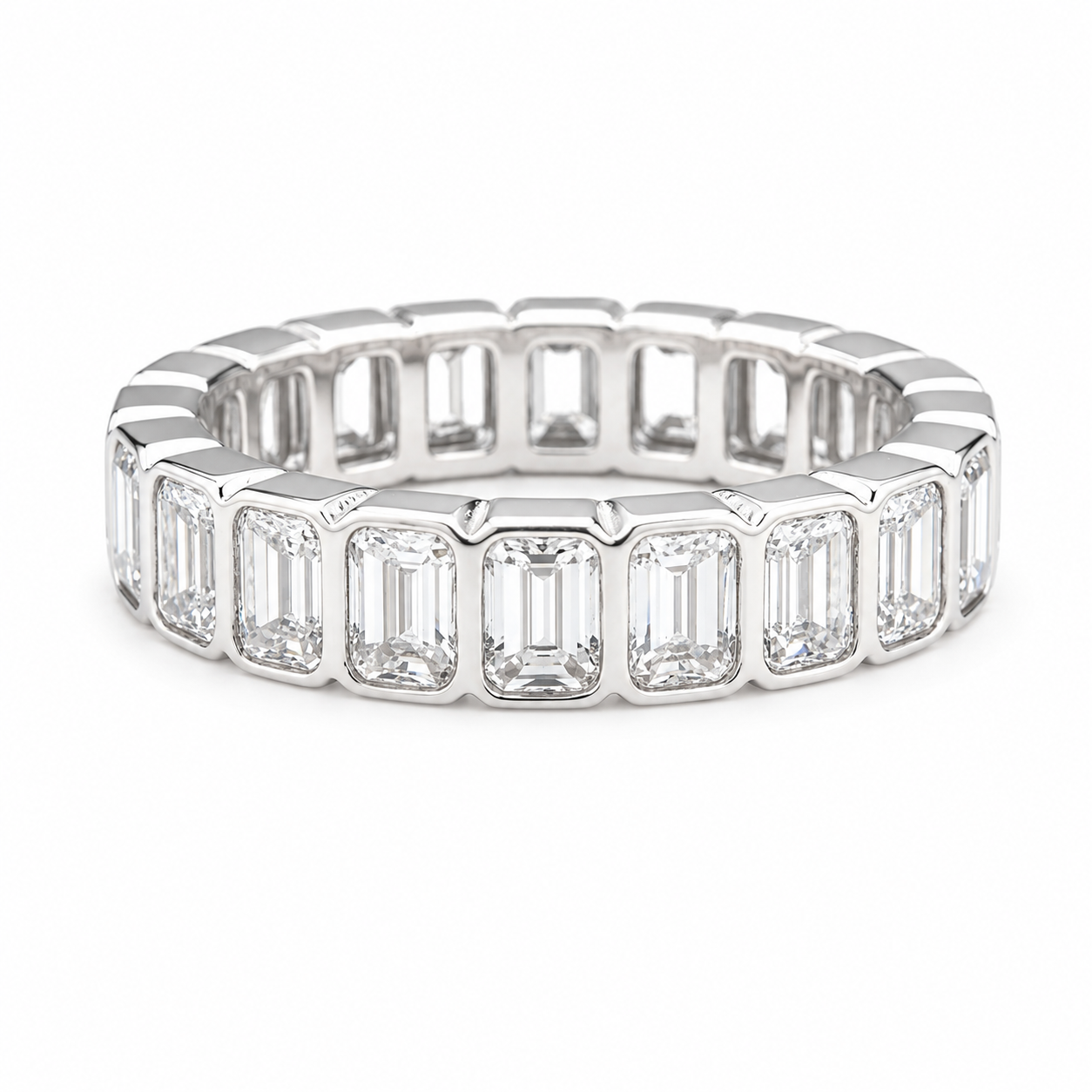 A white gold eternity ring featuring a row of baguette-cut clear gemstones, shown on a clean white background.