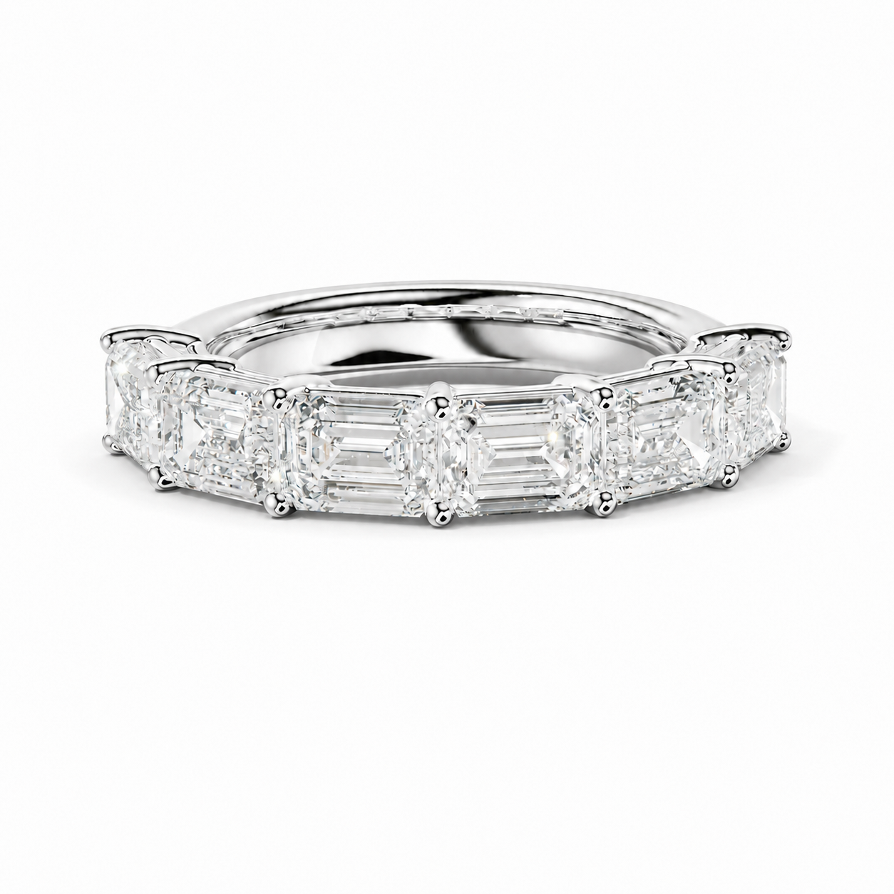 A diamond eternity ring featuring baguette and round-cut diamonds set in a polished white gold or platinum band, shown on a clean white background.