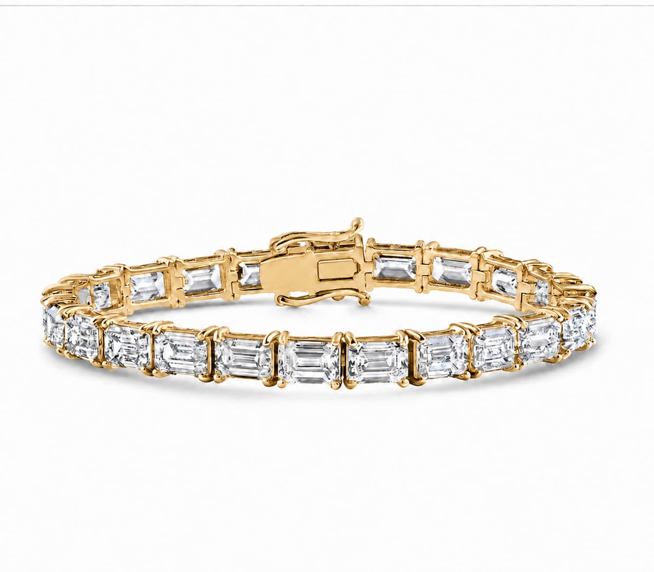 A yellow gold tennis bracelet featuring baguette-cut clear gemstones in a continuous link design, shown on a clean white background.