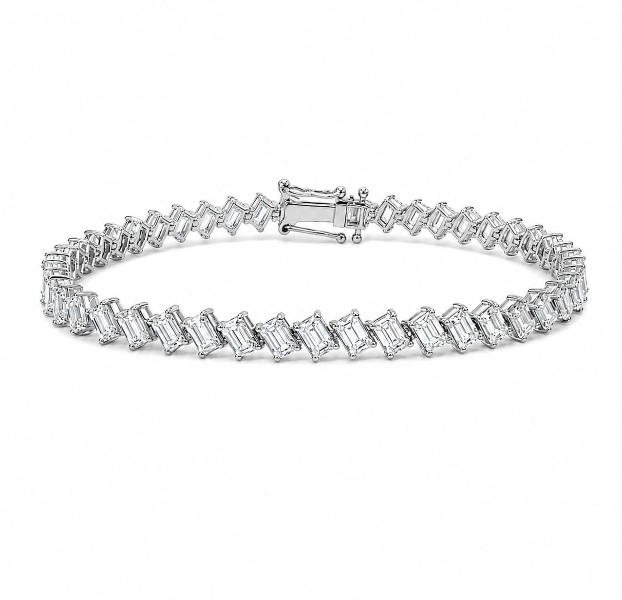 A silver tennis bracelet featuring baguette-cut clear gemstones, displayed against a clean white background.