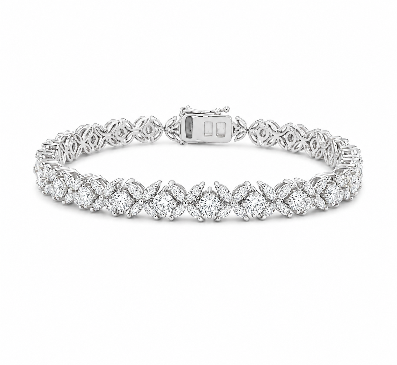A silver tennis bracelet featuring a continuous row of round-cut clear gemstones in a pavé setting, with a clasp closure, shown on a plain white background.