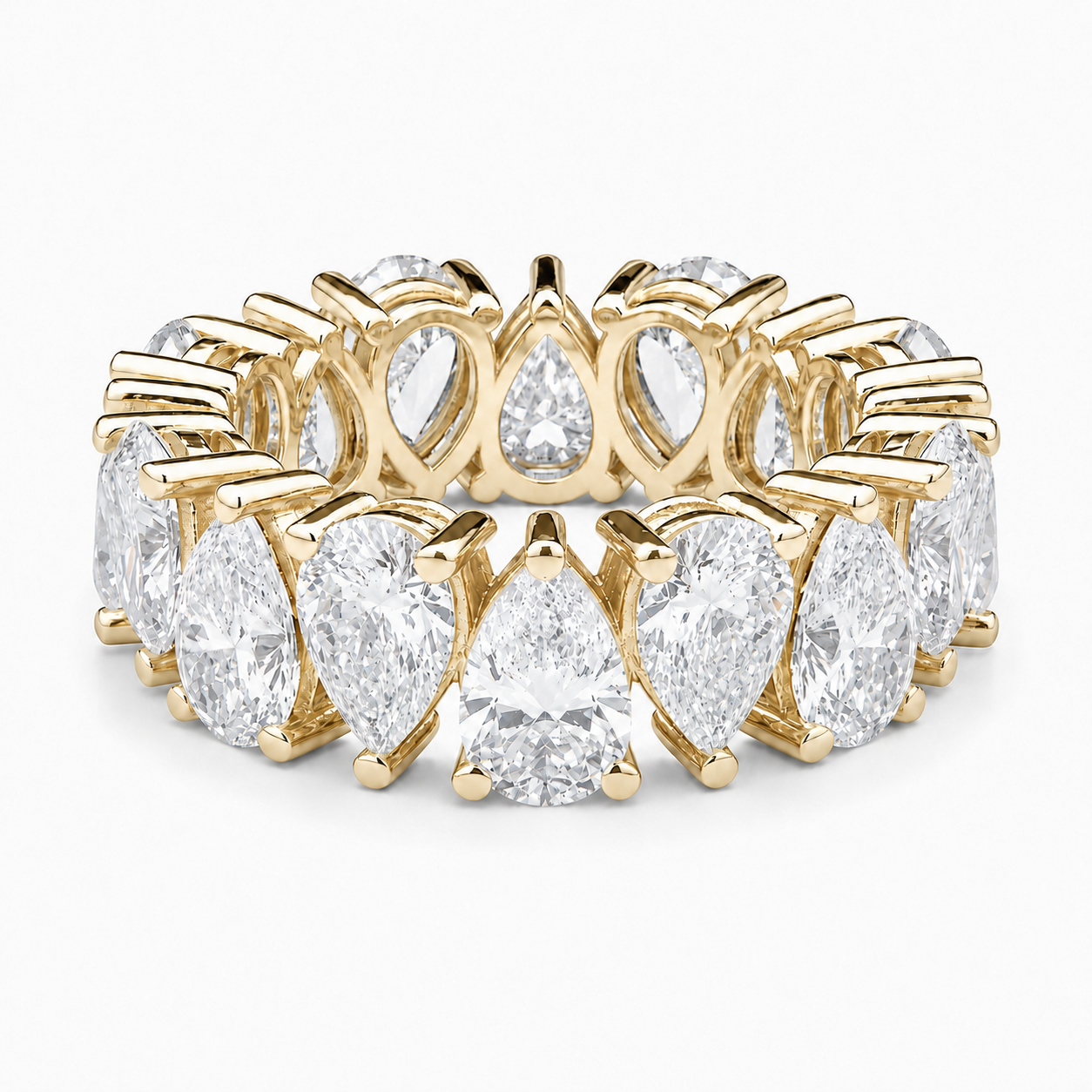 A yellow gold eternity ring featuring a continuous row of brilliant-cut diamonds in marquise and round shapes, set against a clean white background.