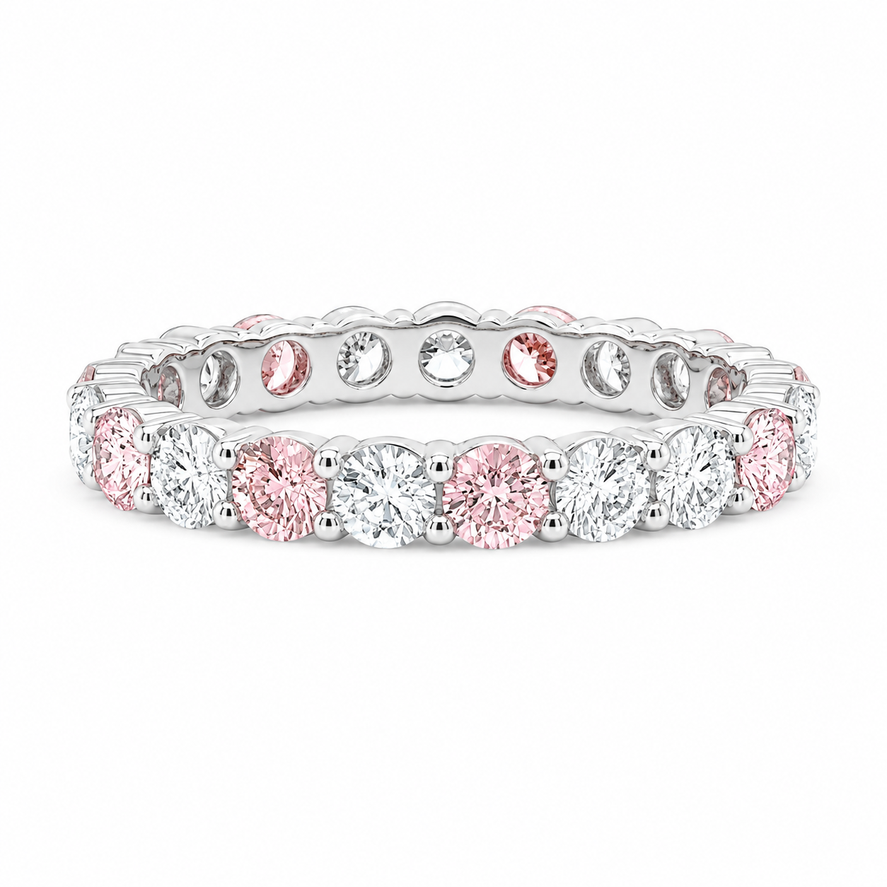 A white gold eternity ring featuring alternating round pink and clear gemstones, set against a clean white background.