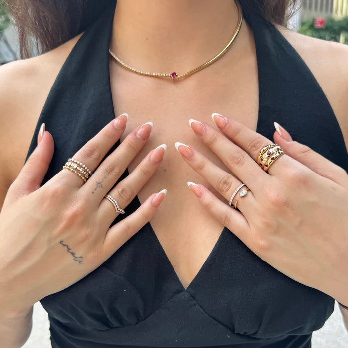 Close-up of a person Ruby & Diamond Inlay Dome Ring in 14K Gold – Classic Gemstone Statement Ringon their fingers with a blurred background