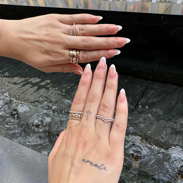 Two hands with Ruby & Diamond Inlay Dome Ring in 14K Gold – Classic Gemstone Statement Ring on fingers against a dark stone background
