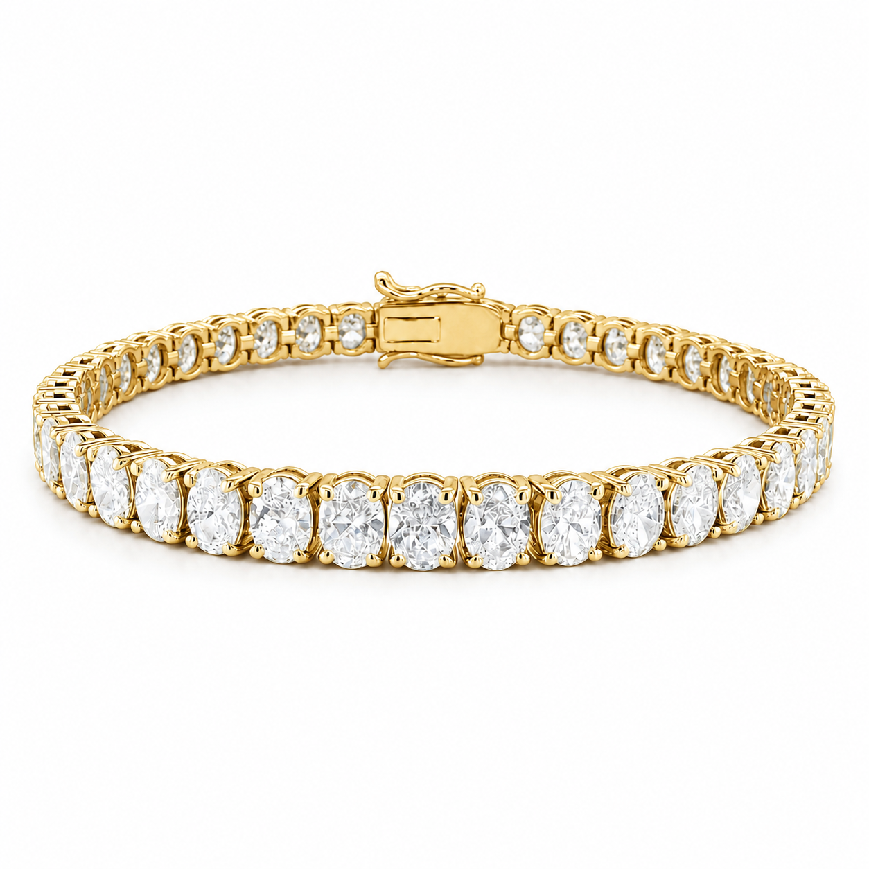 A yellow gold tennis bracelet featuring a row of oval-cut clear gemstones in a prong setting, with smaller accent stones along the sides and a clasp visible at the back, shown on a plain white background.