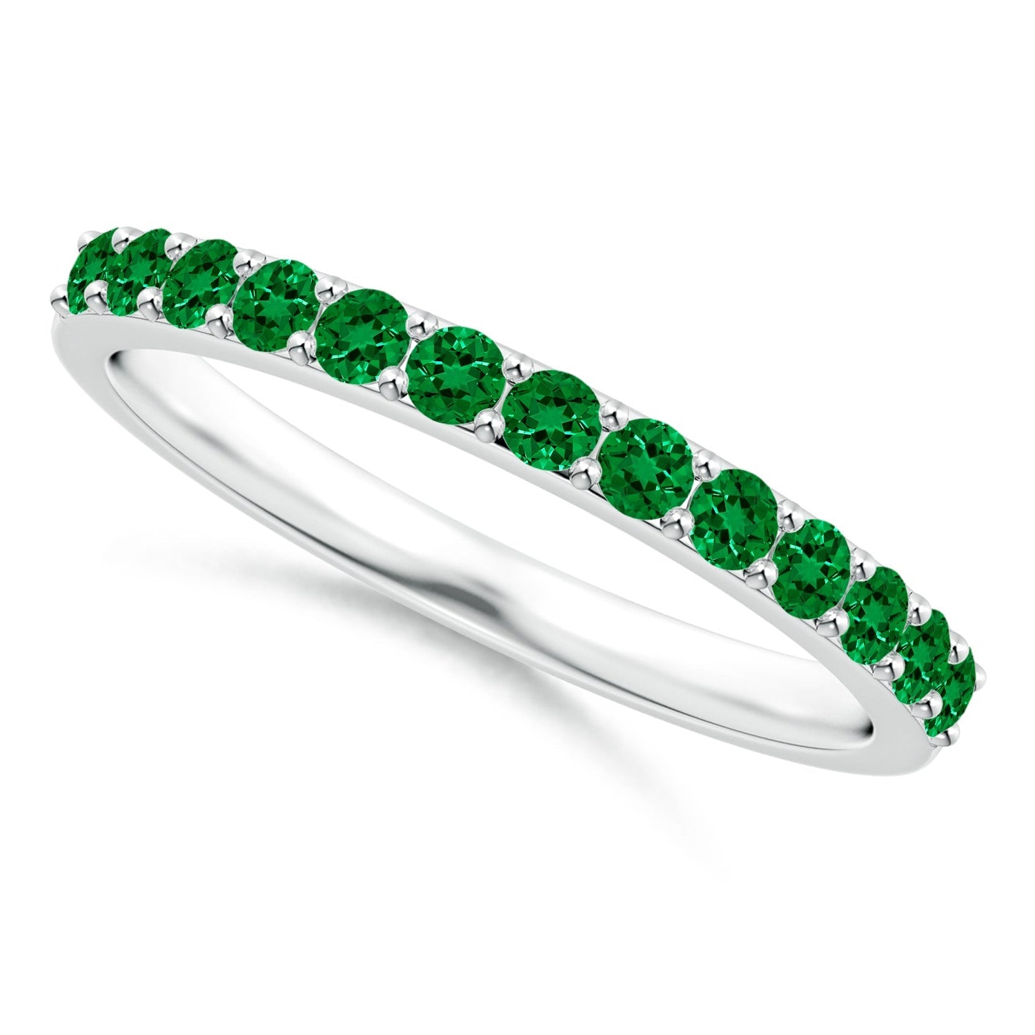Ring with green gemstones on a white background